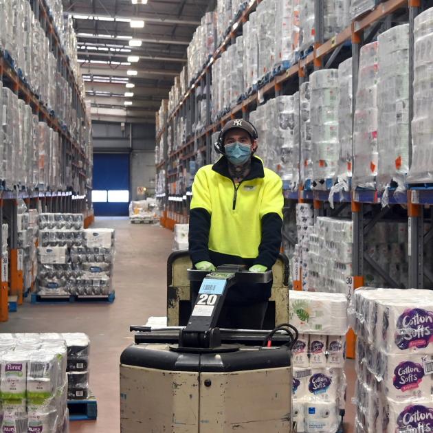 Foodstuffs store worker Dorian Fletcher moves a pallet of toilet paper around the Dunedin...