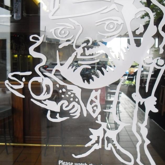 Mark Templeton's distinctive caricature on the window at Temps Bar in Goulding St, Hornby. Photo:...