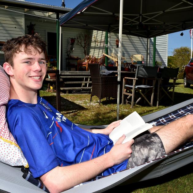 Chilling out in a hammock at the family crib in Karitane is Paddy Borthwick of Dunedin. PHOTO:...
