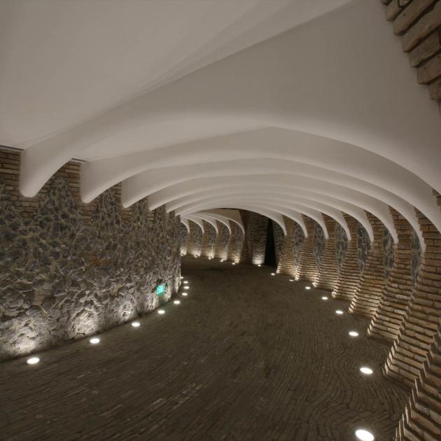 A subterranean entrance to the Marisfrolg Headquarters made from concrete, recycled bricks and...