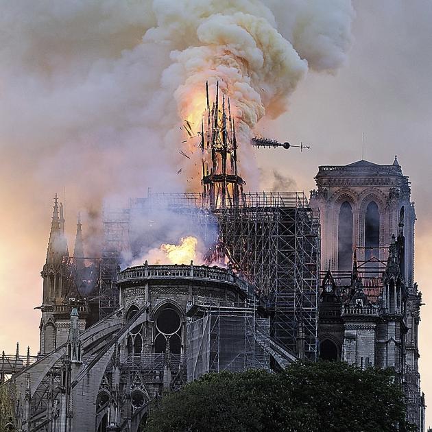 Flames and smoke rise as the 91-metre-high spire on Notre Dame cathedral collapses. Photo: AP