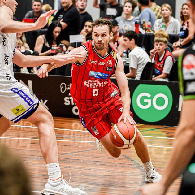 Thomas Bird captures Taylor Britt of the Canterbury Rams looking to drive forward. Photo: Thomas...