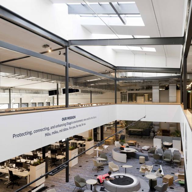 In the main office space, traditional desks, along with round tables and ‘‘pods’’ designed for...