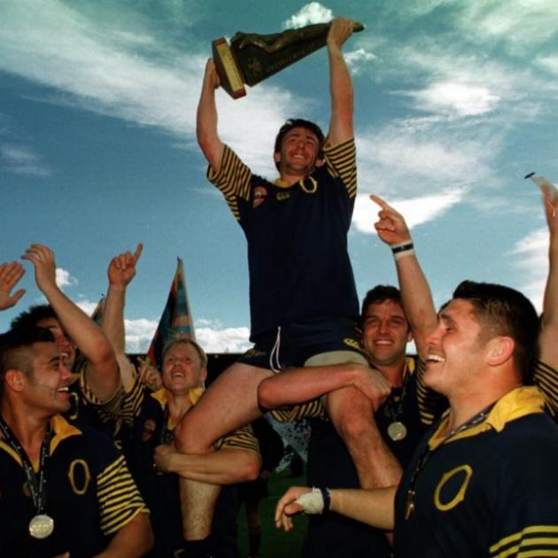 John Leslie lifts the trophy for winning the national provincial competition at Carisbrook in...