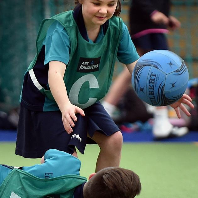 East Taieri School's Amelia Thorburn (8) offers a helping hand to team-mate Daniel Joint (10). Photos by Peter McIntosh.