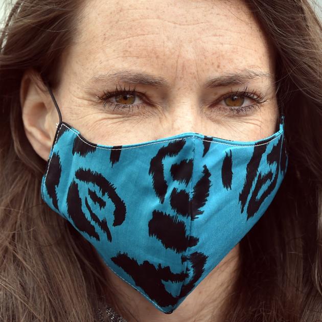 Esther Paterson dons a compulsory face mask for public transport travel at the Bus Hub in Dunedin. 