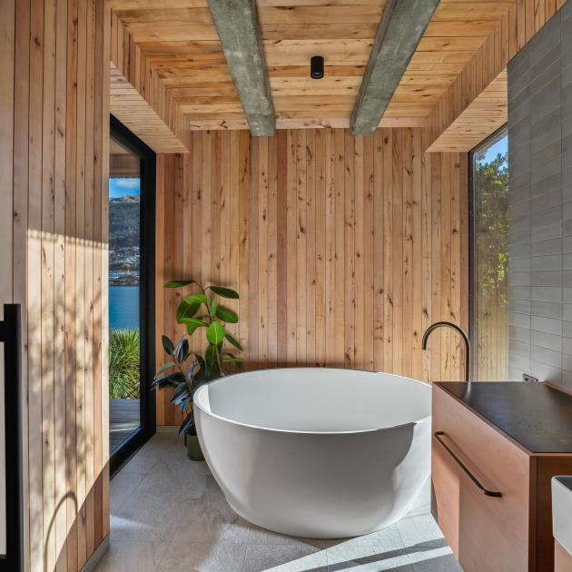 A large round bath is a focal point in this bathroom, which has access to an adjoining deck. 