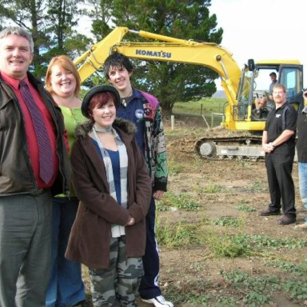 The Heron family (from left) Peter, Debbie, Holly, and William are thrilled work has started on their new home at Waipiata after their villa was destroyed by fire in August last year. Working on site are (from right) builders Paul and Greg Baddock, and Mc