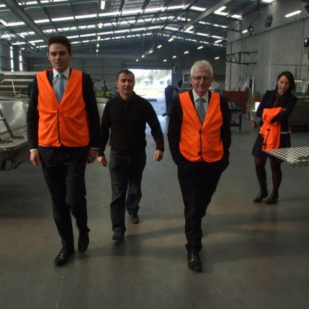 Visiting the McLay Boats warehouse in Milton, yesterday, are (from left) National candidate Todd Barclay, business owner Steve McLay, Trade Minister Tim Groser and National Pparty staffer Fleur Thompson. The manufacturer exports 40% of its boats. Photo by