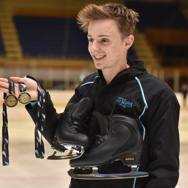 Reuben Dougherty displays his gold medals from the national figure skating champs last week. Photo by Gregor Richardson.
