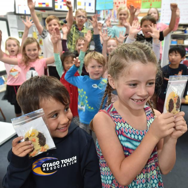 Kaikorai Primary School pupils Tiaki Herewini and Isla Marshall (both 6) hold a couple of the penguin cookies they baked to raise funds for the Dunedin Wildlife Hospital Trust. Photos by Gregor Richardson.