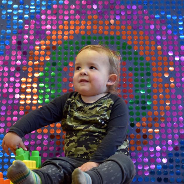 Espen Stringer-Shaw (2½), of Dunedin, with a sequin board which shows the effect of sound waves from a sound cannon, at Dunedin Hospital yesterday. Photo: Peter McIntosh