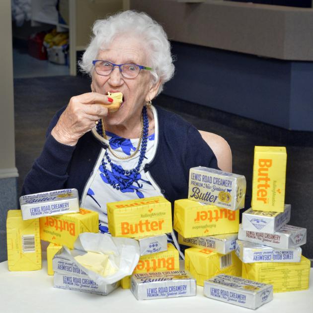 Dunedin centenarian Olga Janssen digs into the butter-covered scone she has craved for so many...