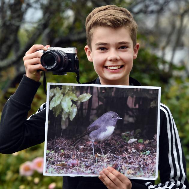 Dunedin boy Jack Aubin holds an image of the robin he and his dad spotted at Ross Creek Reserve...