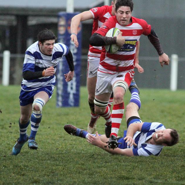 Clutha co-captain Simon Grant muscles his way over a Heriot tackler in the side's semifinal win...