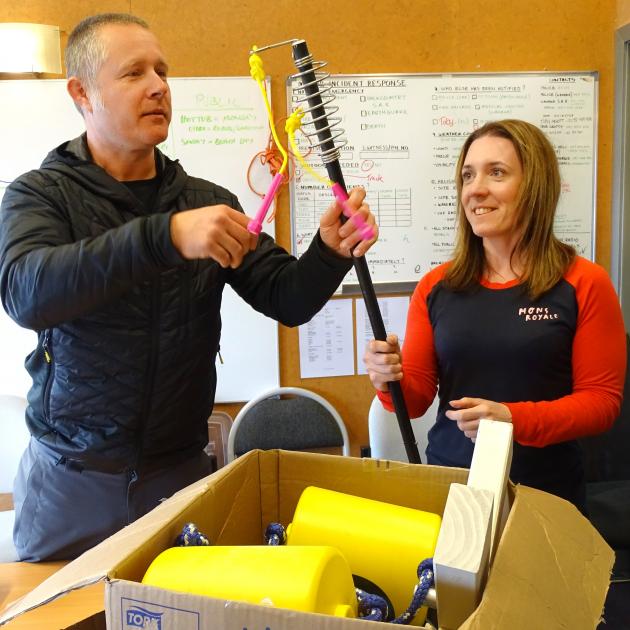 Treble Cone brand manager Richard Birkby helps health and safety officer Jessica Griffin unpack...
