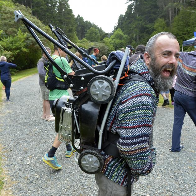 Andrew Glennie carted a lawnmower on his back while completing four laps in the Cargill Crusher...