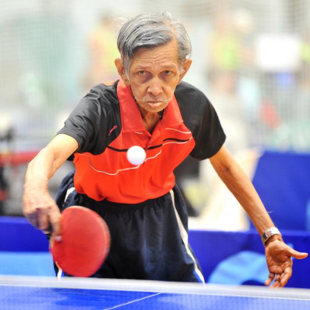 Gerard Lucas is all motion in a table tennis match at the masters games at the Edgar Centre...