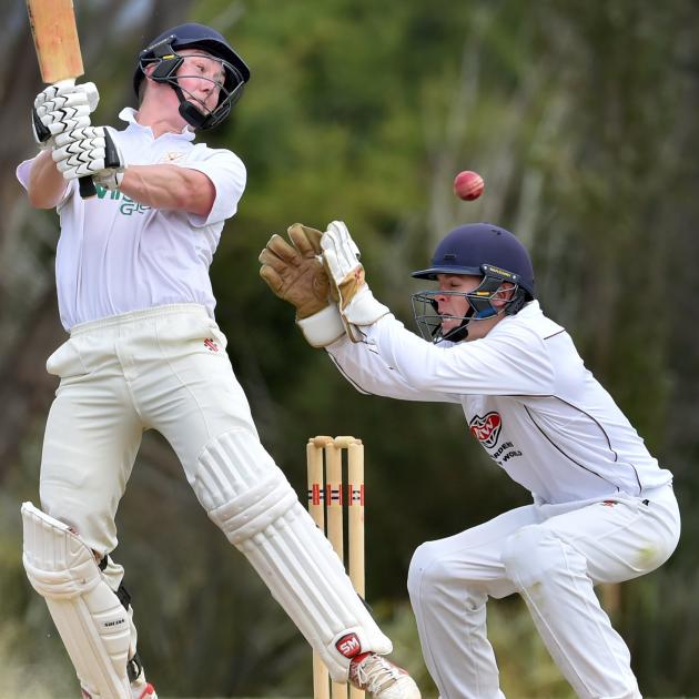 Green Island opener Geordie Scott looks to guide the ball past North East Valley wicketkeeper...