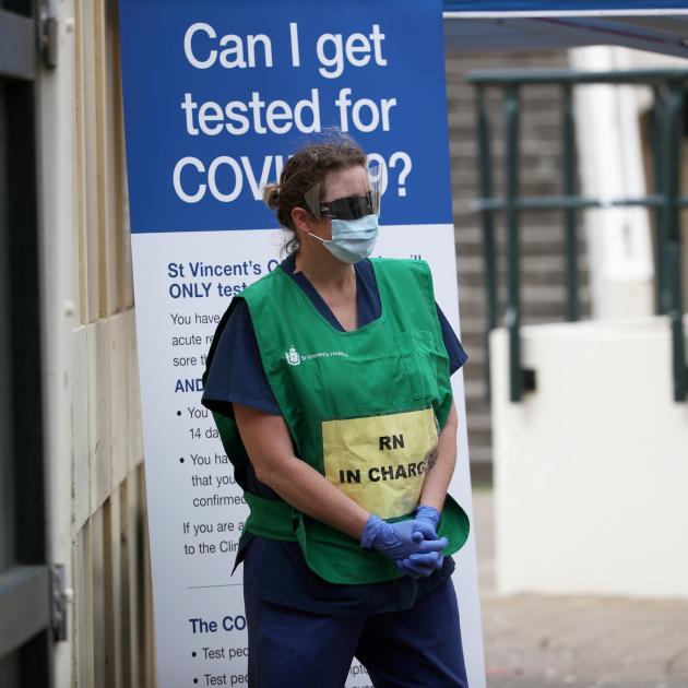A healthcare professional waits at a pop-up clinic testing for coronavirus at Bondi Beach in...
