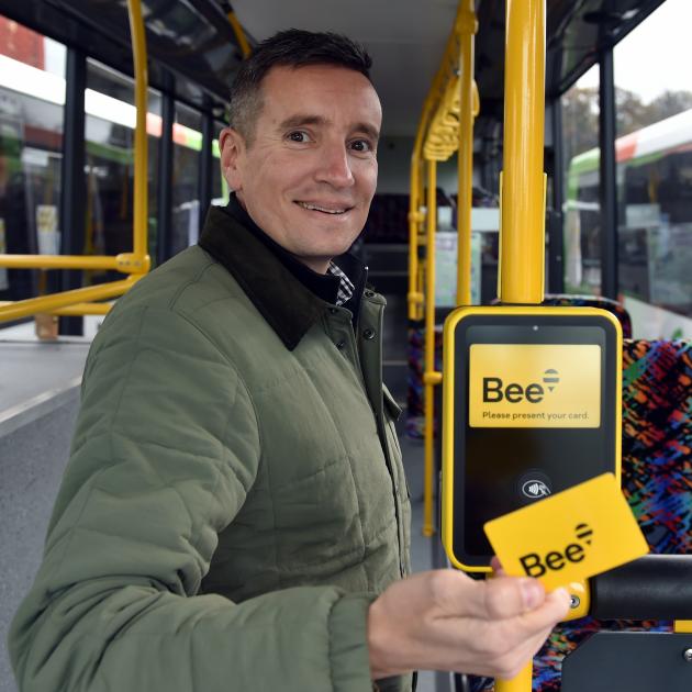 Otago Regional Council public transport team leader Julian Phillips shows off the new tag on-tag...