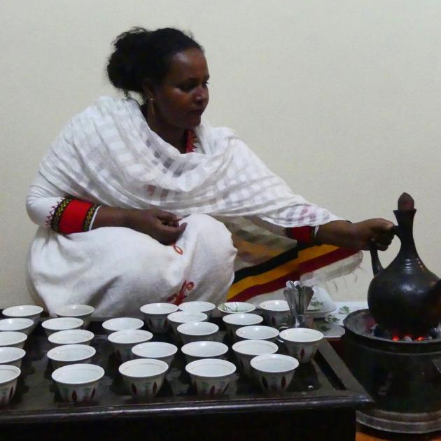 Sisaynesh Gebeyaw with the jebena (coffee pot) on a charcoal brazier and cups at the ready.


