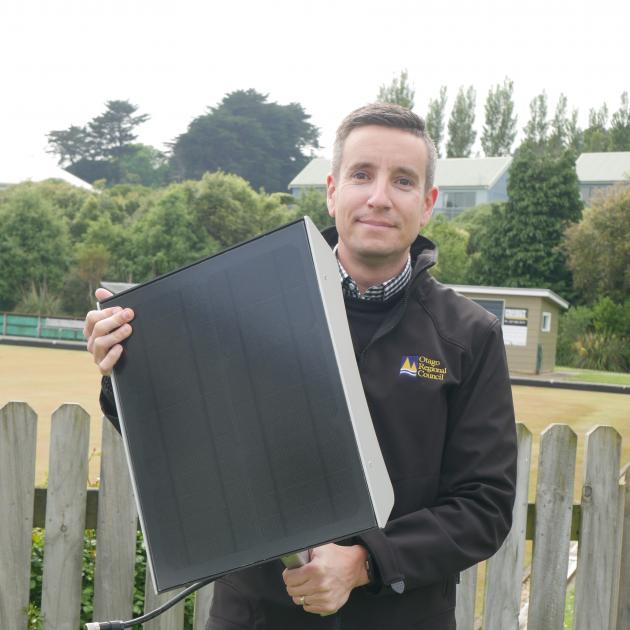 Otago Regional Council public transport team leader Julian Phillips holds a solar panel which...