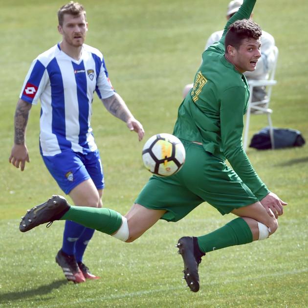 Green Island player Matthew Brazier flicks the ball with his heel during the South Island...
