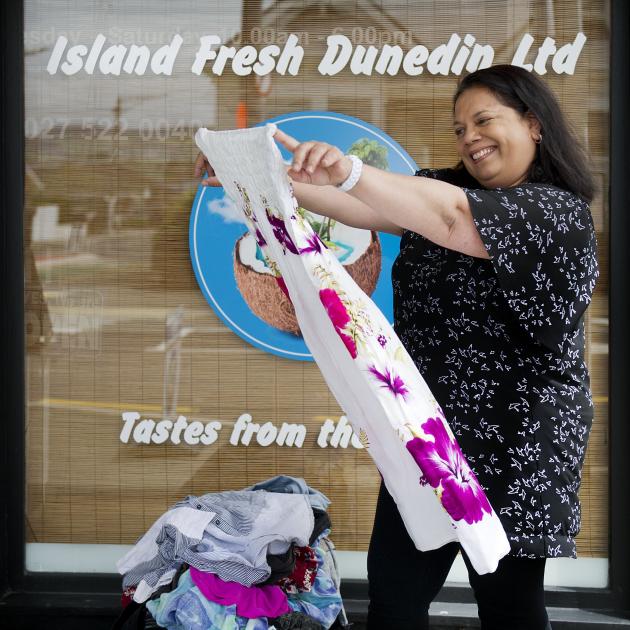 Island Fresh Dunedin owner Regina Khan sorts through some of the children’s clothing that is to...