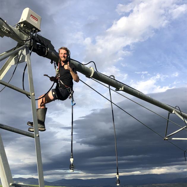 Lincoln University student Cameron Butterworth, who is spending the summer on work placement at Tinwald Farm, used his climbing gear to repair an irrigation pivot last week. PHOTO: SUPPLIED BY AMANDA CURRIE Lincoln University student Cameron Butterworth, who is spending the summer on work placement at Tinwald Farm, used his climbing gear to repair an irrigation pivot last week. PHOTO: SUPPLIED BY AMANDA CURRIE