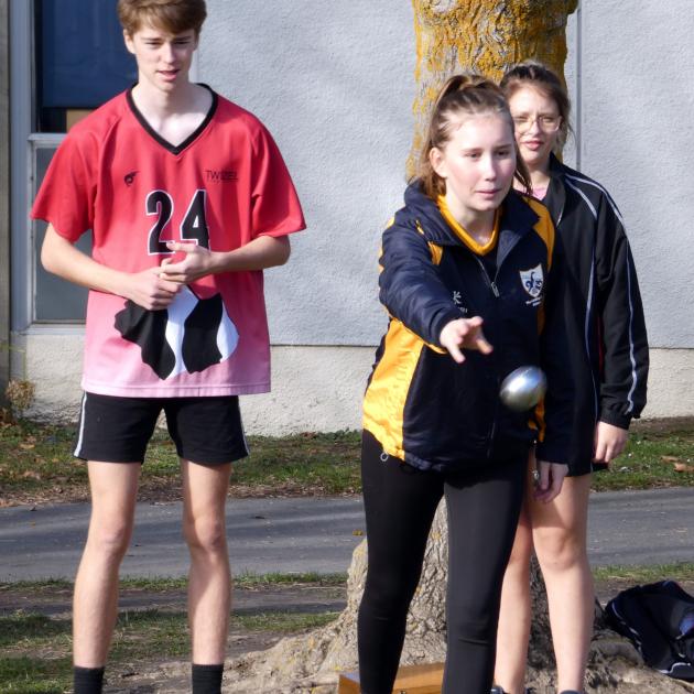 Beth Kirkpatrick (17), of Roxburgh Area School, throws a boule during a petanque game.
