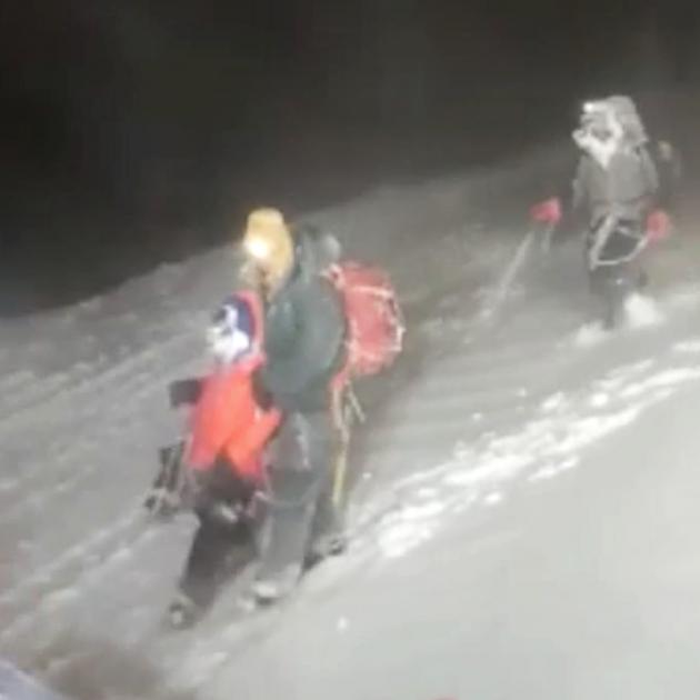 Members of Russia's Emergencies Ministry help a group of climbers stuck on Mount Elbrus on...