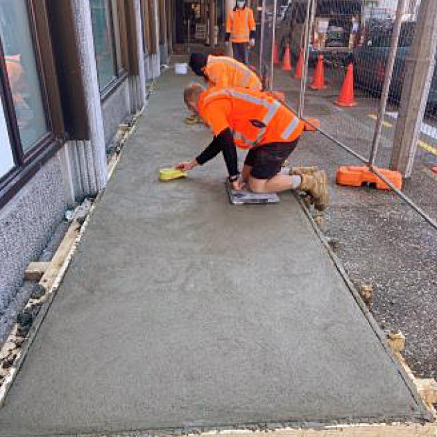 Workers form concrete bases for two large fans as part of a Covid-19 ventilation upgrade at...