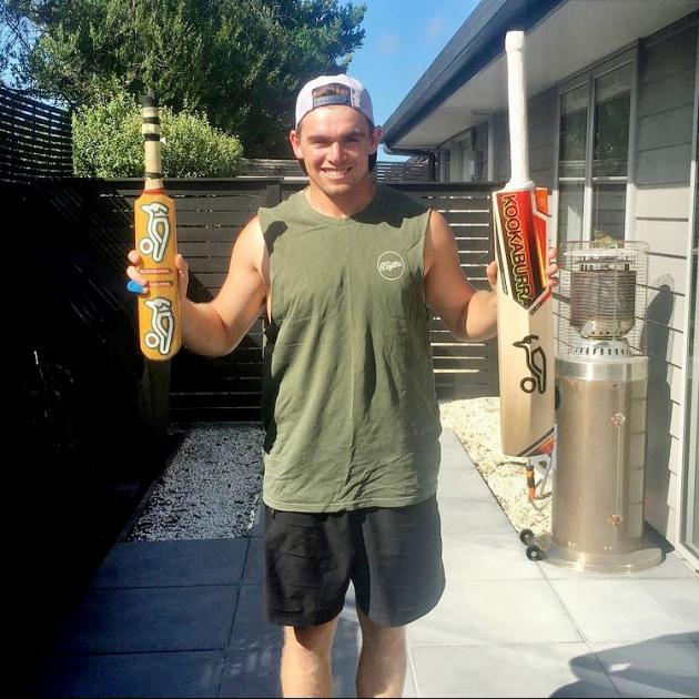 Tom Latham with the first cricket bat he used and a Kookaburra of a more recent vintage. Photo:...