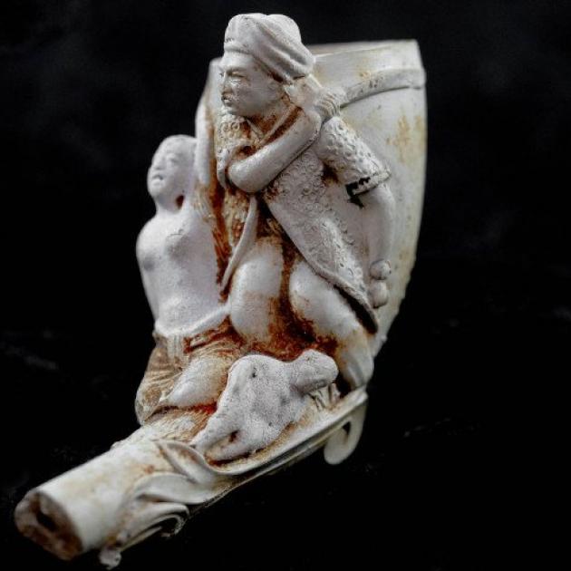 The clay pipe was made by French pipe manufacturing firm L. Fiolet and depicts a European view of...