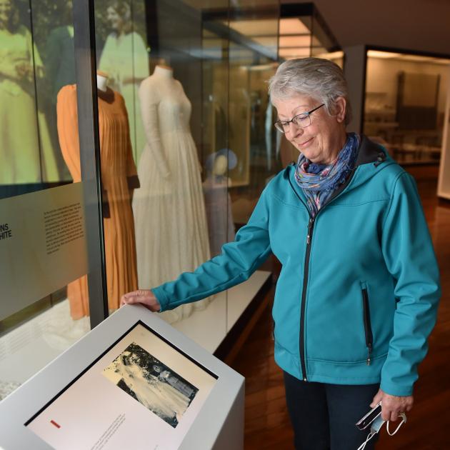 Rosalie Young admires a photo of herself (right) as a 3-year-old flower girl at her late sister...