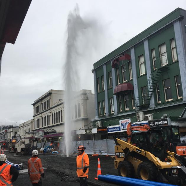 A burst fire hydrant on George St is sending water four storeys into the air. Photo: Gerard O'Brien 