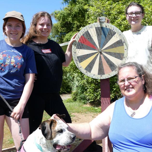 Sisters (from left) Danni (16), Sophie (18), and Rebecca (19) Clark man the chocolate wheel with...