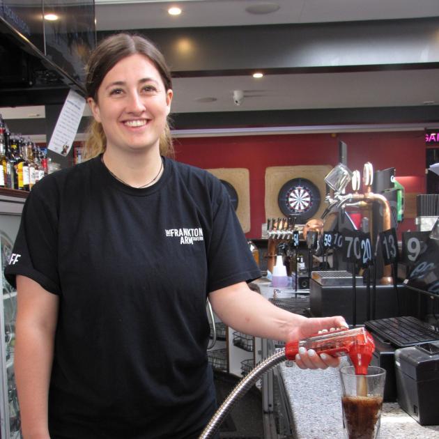 Work gets back to normal for bartender Phoebe Van Sommeren at the Frankton Arm Tavern.