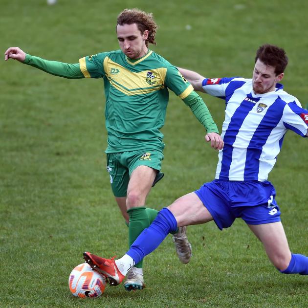 Green Island forward Trevin Myers (left) battles Cashmere Technical defender Danny Kane during a...