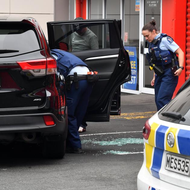 Dunedin police search a vehicle in St Andrew St following a report it had been hit by gunfire...