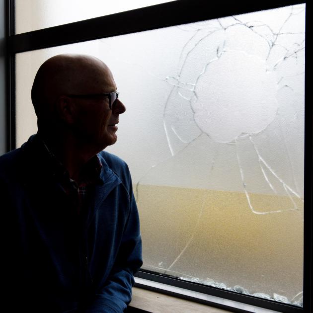 Caversham Baptist Church pastor Murray Gordon looks at a shattered window in the church, caused...