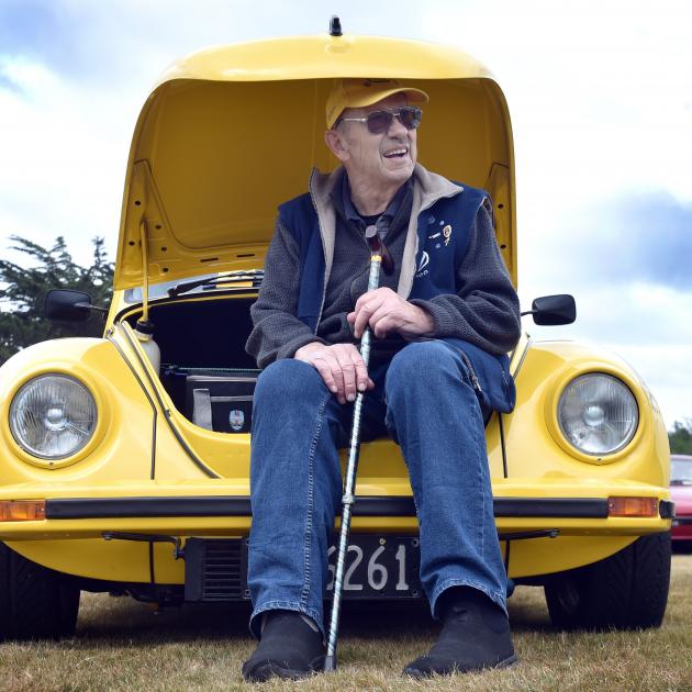 Ken Berry sits in the front of his rear-engine 1975 Volkswagen Beetle on display at the Dunedin...