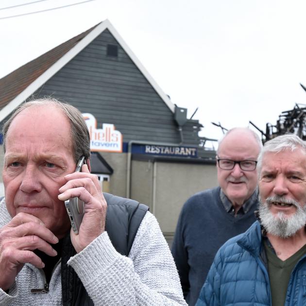 Mitchells Tavern Social Club president Tony Manley (left) stands outside the remains of the...