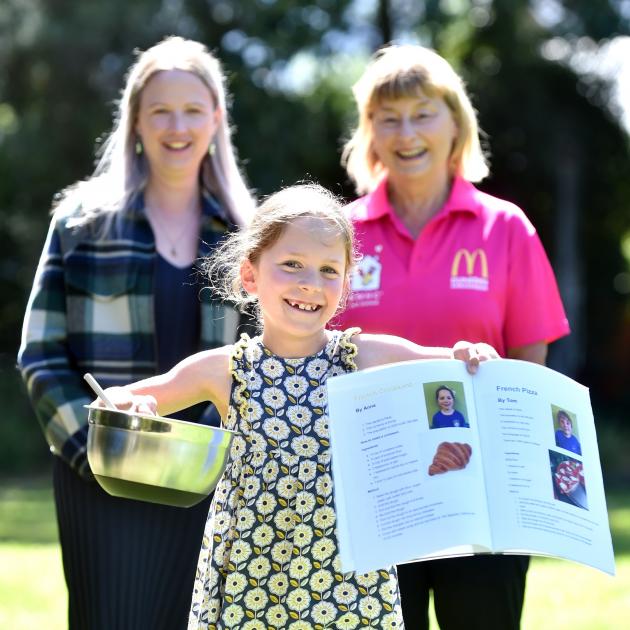 Macandrew Bay School year 4 pupil Anne Bertoli, 8, holds a cookbook she and her peers made to...