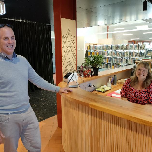 Oxford Area School principal Mike Hart chats to morning receptionist Rachel Stagg in the new...