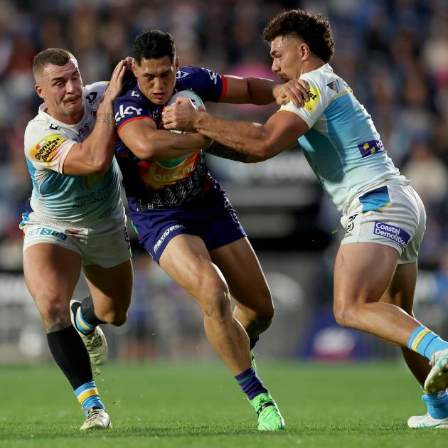 Addin Fonua-Blake of the Warriors is tackled during the Anzac Day clash against the Titans in...