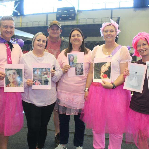 Holding pictures of loved ones who had cancer are, from left, Freddie Muller, Antonette Lexton,...
