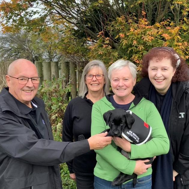 Celebrating the gift of Labrador puppy Skye to the K9 Medical Detection training programme are ...