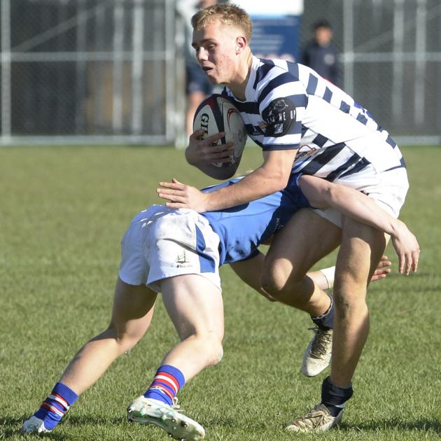 Otago Boys' High School fullback Mack Wrigley is wrapped up in a tackle by his Southland Boys...